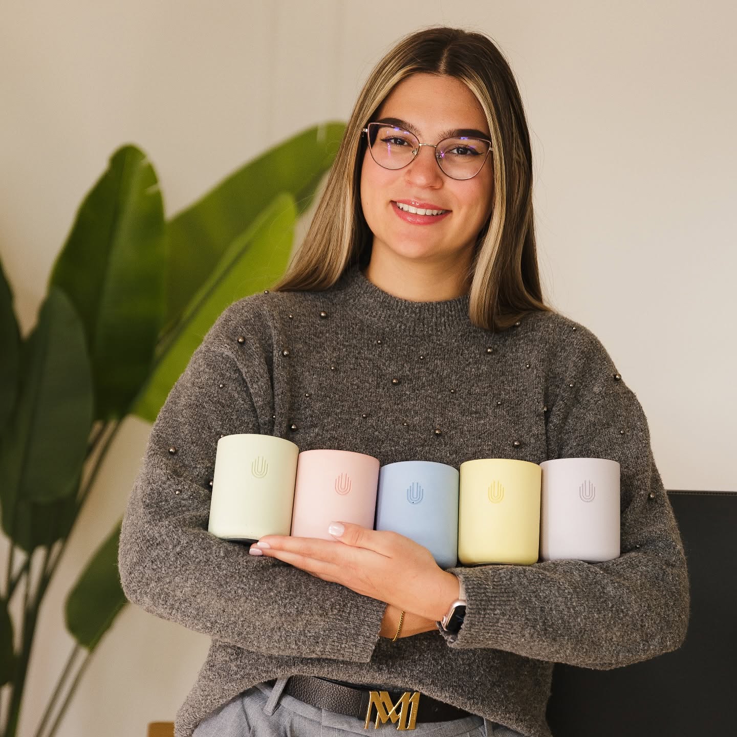 UnityCave team holding the Heritage MagSafe stand in all five colours